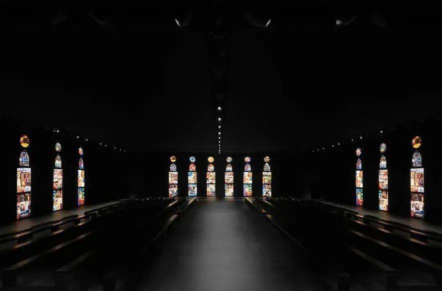 秀场中的巨大灯箱装置,致敬哥特式大教堂的彩色玻璃窗,其中背景拼贴