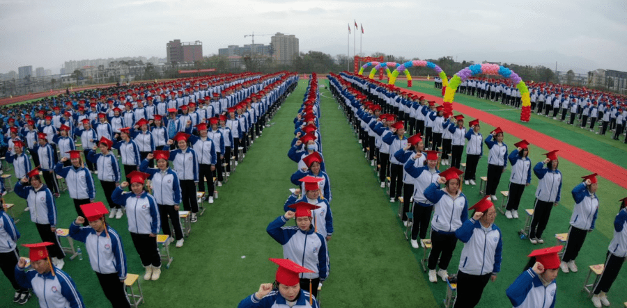 遂川燕山中学的高三学生齐聚操场,头戴"小红帽",庄严宣誓