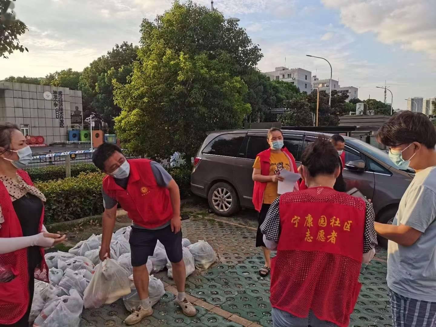红马甲湿透了,没有一人早退,去年的战疫志愿者在小区封闭管理后又来"