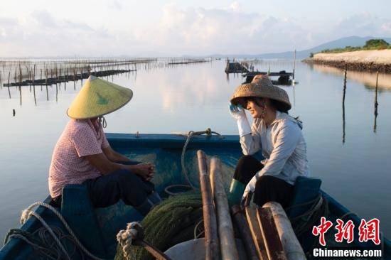 8月17日,从陇石村出发赶海,"阿渔妹"和母亲在渔船上聊天.