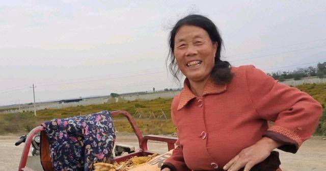 涝灾过后,农村老人滩涂地里捡玉米,小伙用袋子挡住脸
