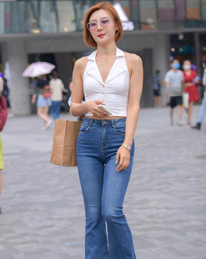 街拍美女白色挂脖上衣搭配牛仔喇叭裤优雅又知性回头率超高