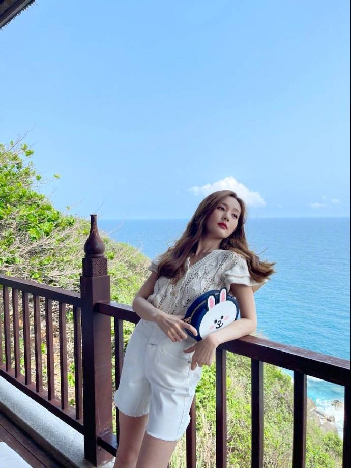 周百福代言人李一桐晒沙滩照,穿粉色度假裙看海景,打扮时髦