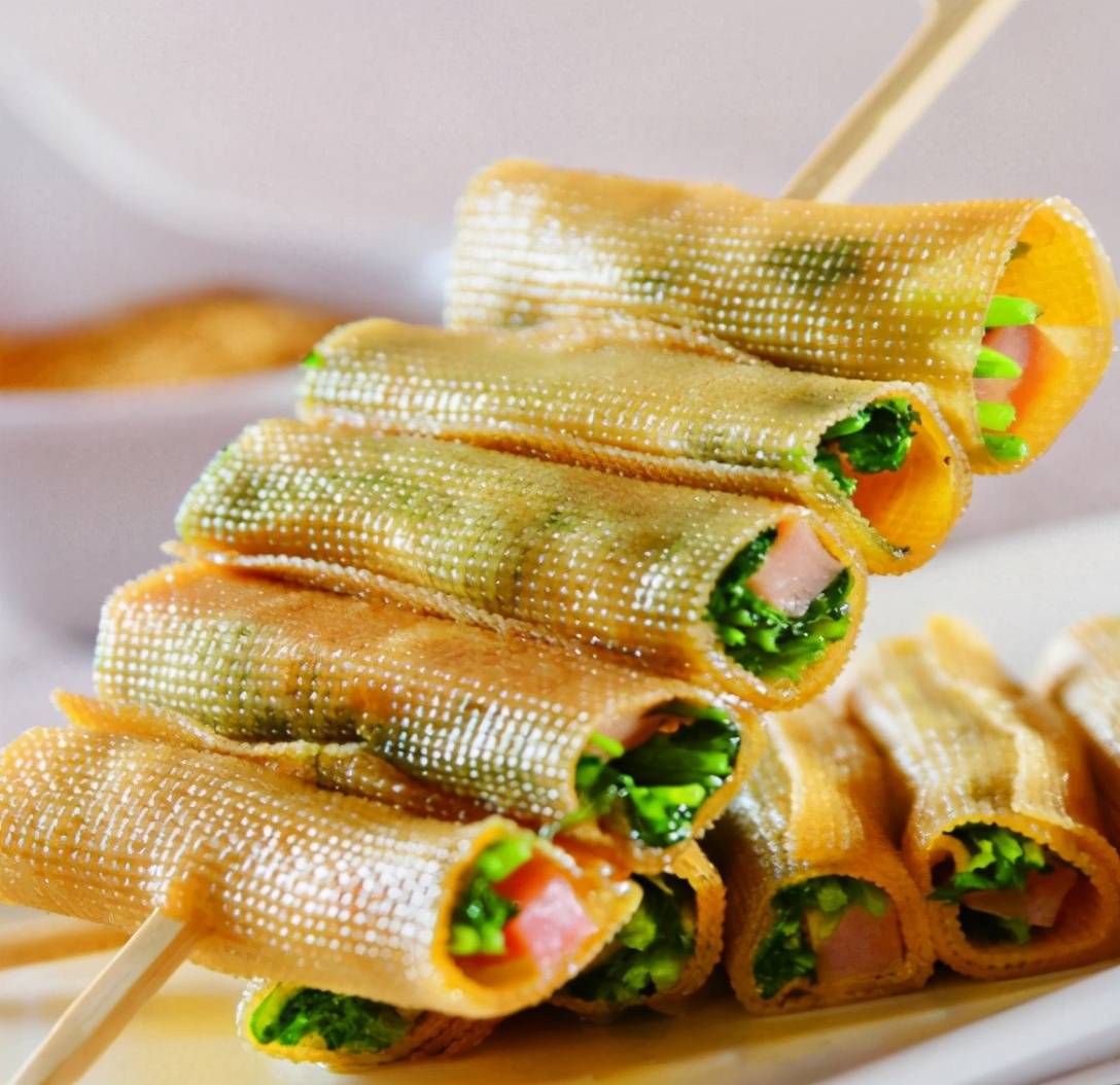 用豆皮卷上韭菜和腊肉,用竹签穿起来放在平底锅上煎,或者直接在烧烤架