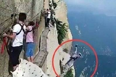 男子在险要栈道解绳索，从容淡定跳崖，原因成谜，吓愣边上的游客