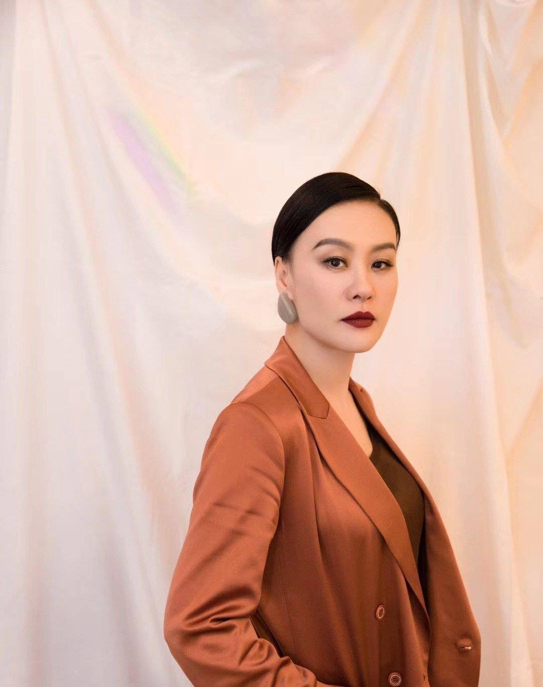 显得|又被邬君梅的气质感惊艳了，缎面西装配低丸子头，简约又大气