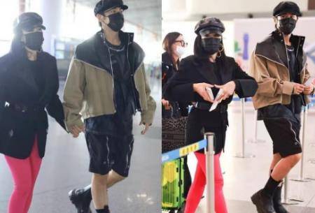 网友 51岁钟丽缇和老公机场被拍！穿粉色裤子造型夸张，亲密靠老公肩上