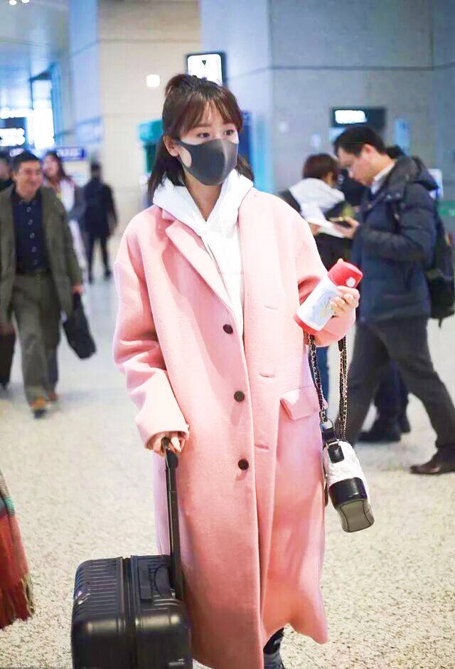 袁冰妍 袁冰妍现身机场，半扎甜美丸子头，白色卫衣叠加粉色大衣，减龄同时还不忘卖萌