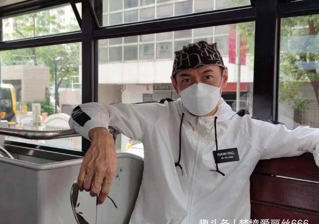 原创58岁江华近况曝光戴字母头巾打扮潮流与妻子坐电车出游状态佳