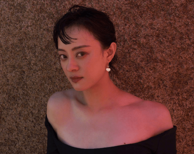 孙俪海边穿抹胸裙优雅妩媚,光脚侧卧礁石如美人鱼