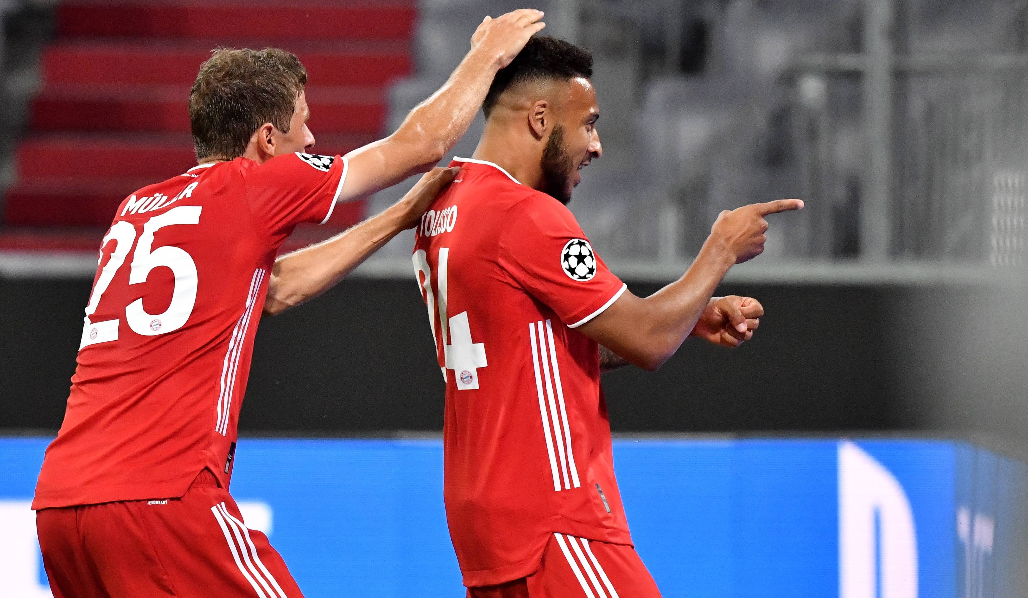 8月8日,拜仁慕尼黑队球员托利索(右)攻入球队第三球后与队友穆勒庆祝.