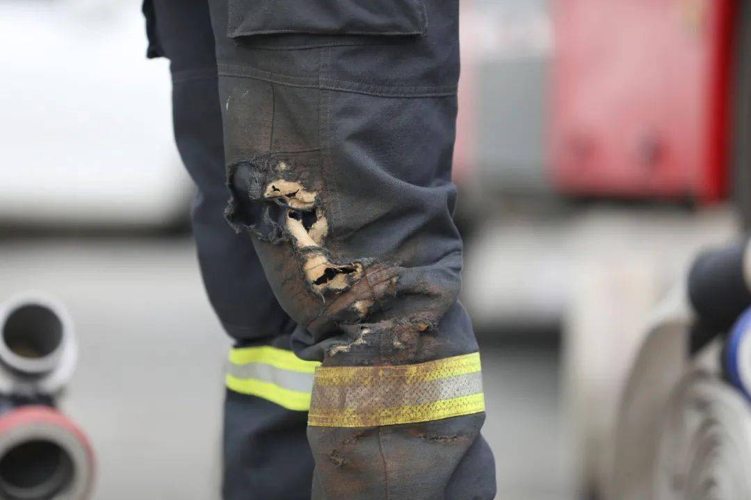 经过长期训练,一名消防员的灭火防护服被磨破