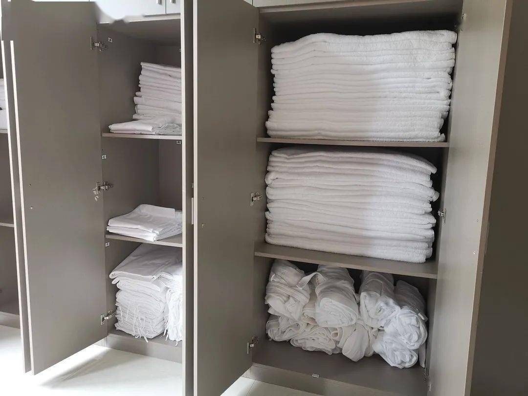 场所布草柜内整齐叠放的棉织品