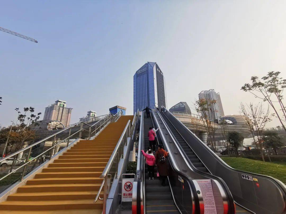 的宝鸡市文化艺术中心人行天桥竣工通行,市民们纷纷乘坐电梯走上天桥