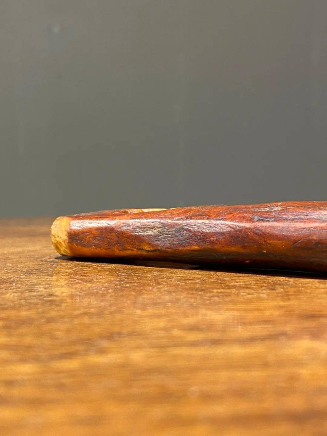 此件藏区牦牛骨随身解绳结器经历逾百年的使用产生温润的包浆皮壳