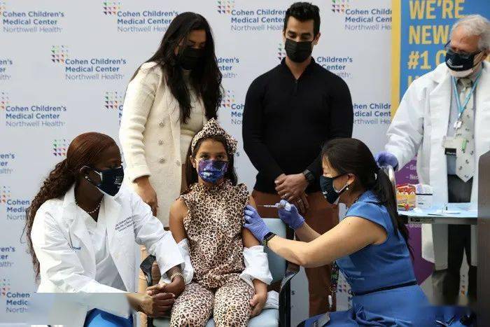desiree mohammadi has her hand held by nurse sandra lindsay, the