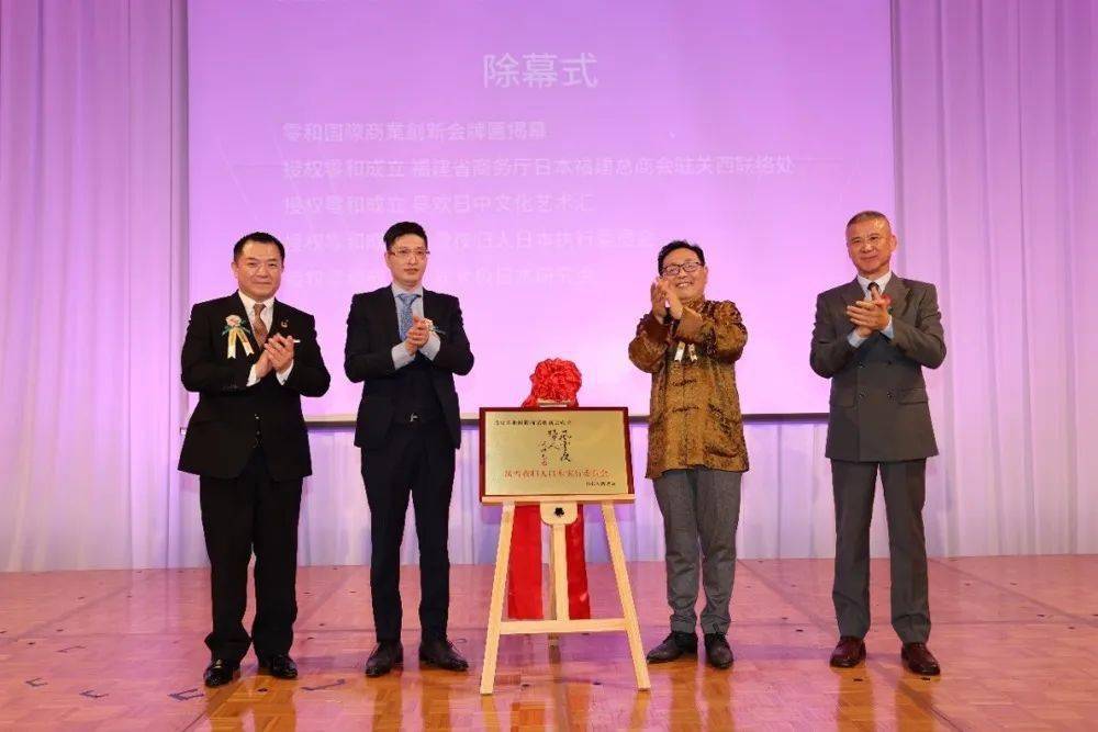 导演陈健骊将"风雪夜归人日本执行委员会"的铭牌交到古川拓海会长手中